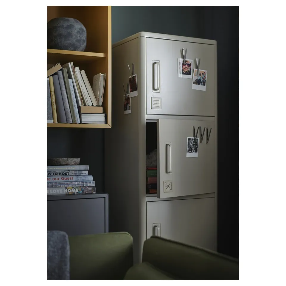 Modern metal locker, IDÅSEN, silver, with magnets for notes, photos. Standing next to shelves with books.