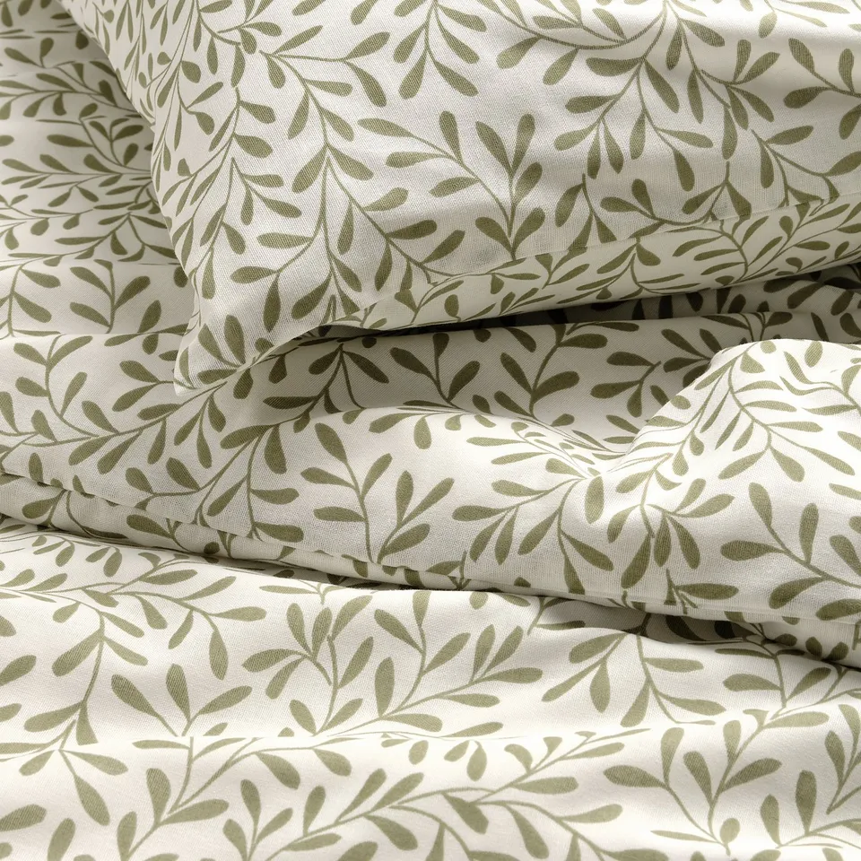 Botanical-themed bedding set with crease-free, breathable fabric, green leaf pattern.