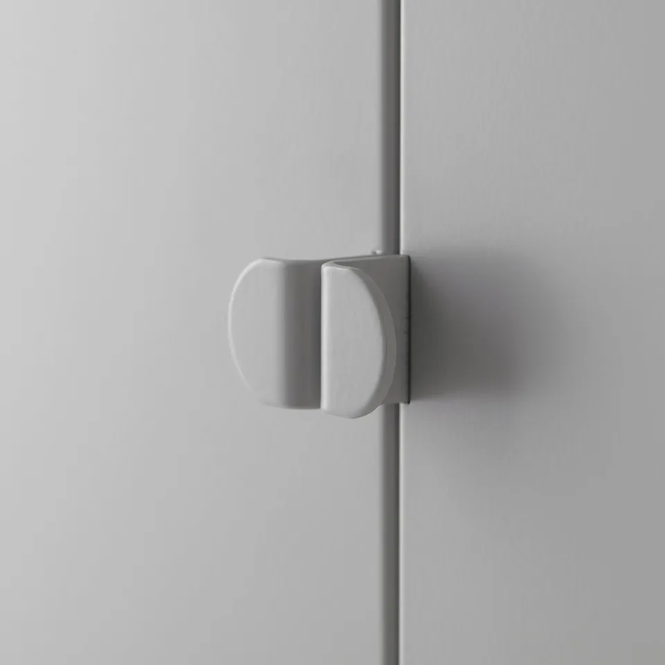 A close-up of a white, modern handle on a smooth, light-colored cabinet door. The handle is simple and sleek, highlighting a minimalist design.