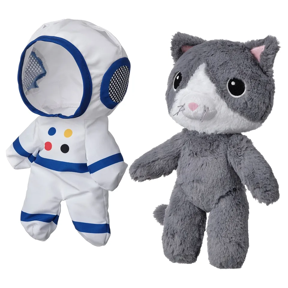 Two stuffed toys: astronaut cat in white & blue, soft grey cat.