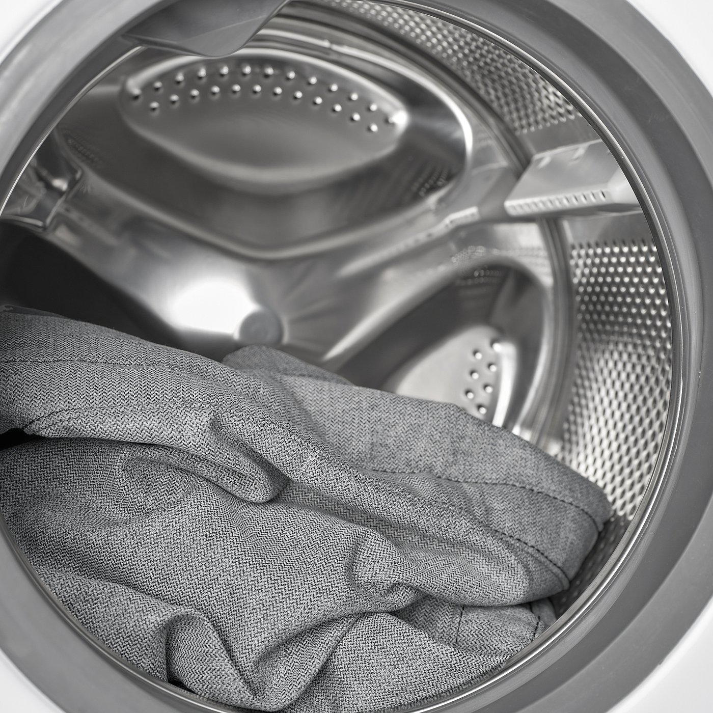 Washing machine drum with fabric, illustrating its capacity and function.