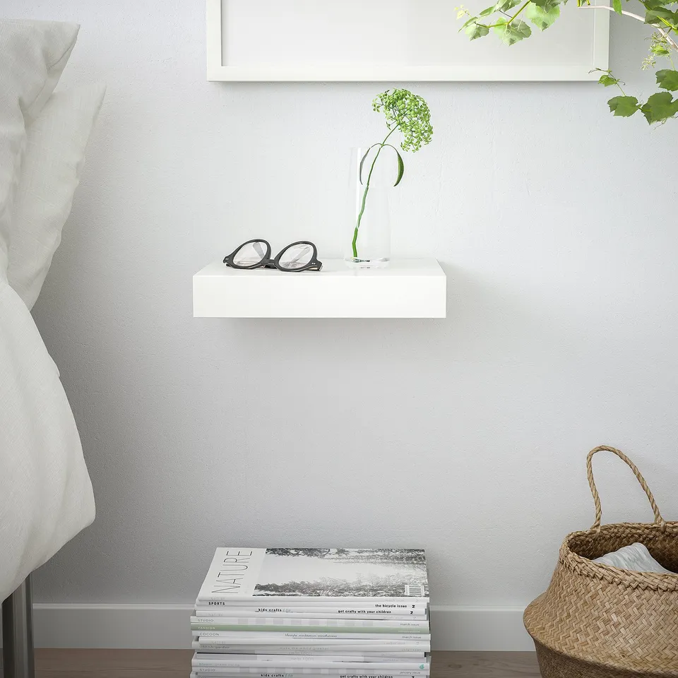 White LACK shelf with glasses, vase, books, and basket.