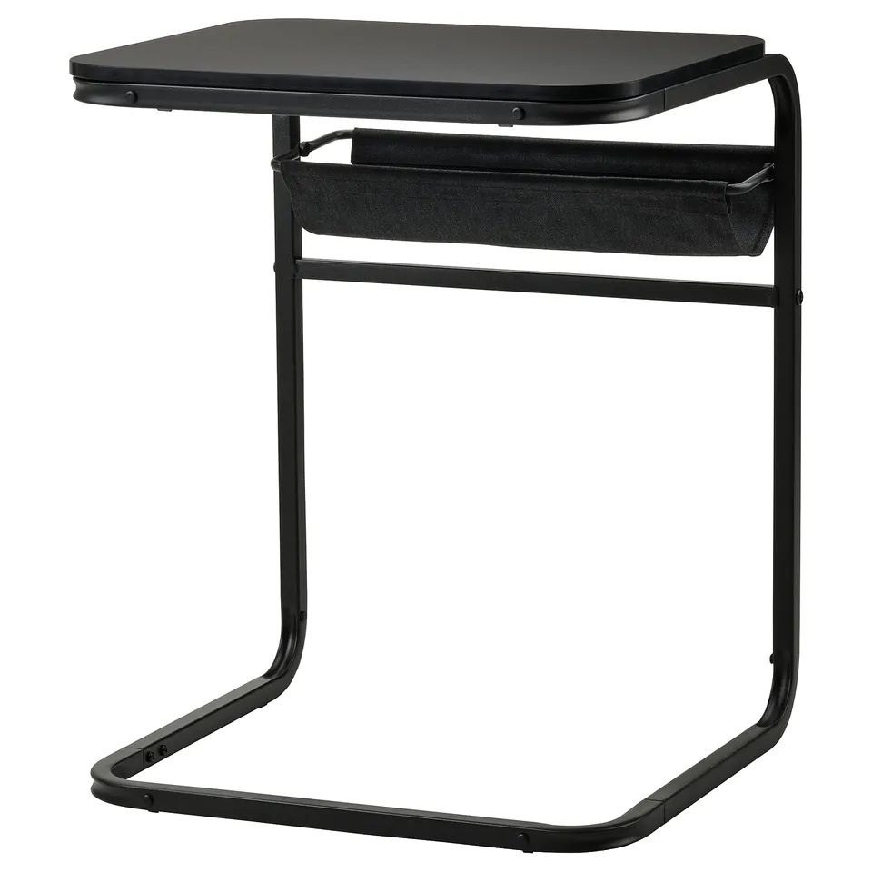 An IKEA OLSERÖD side table in black with a fabric storage pouch, designed to transform from a sofa-side table to a coffee table.