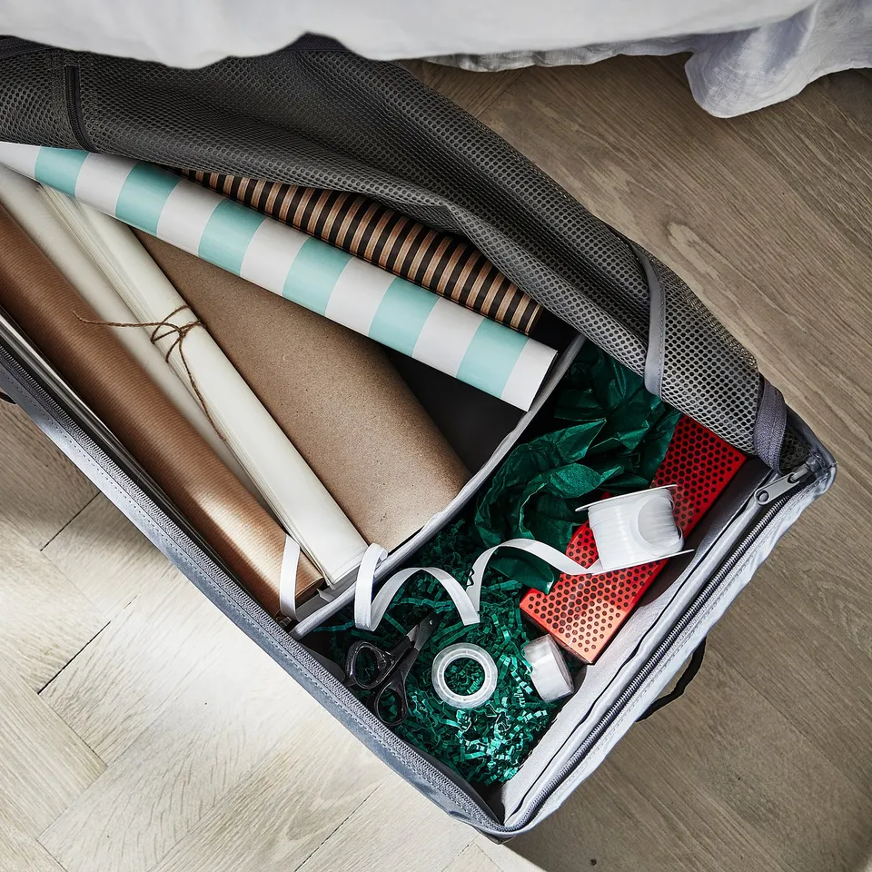 SKUBB storage case with gift wrap, ribbons, and tape in grey, black, brown, white, teal. Rectangular, zipped, handles, mesh top, fabric material.