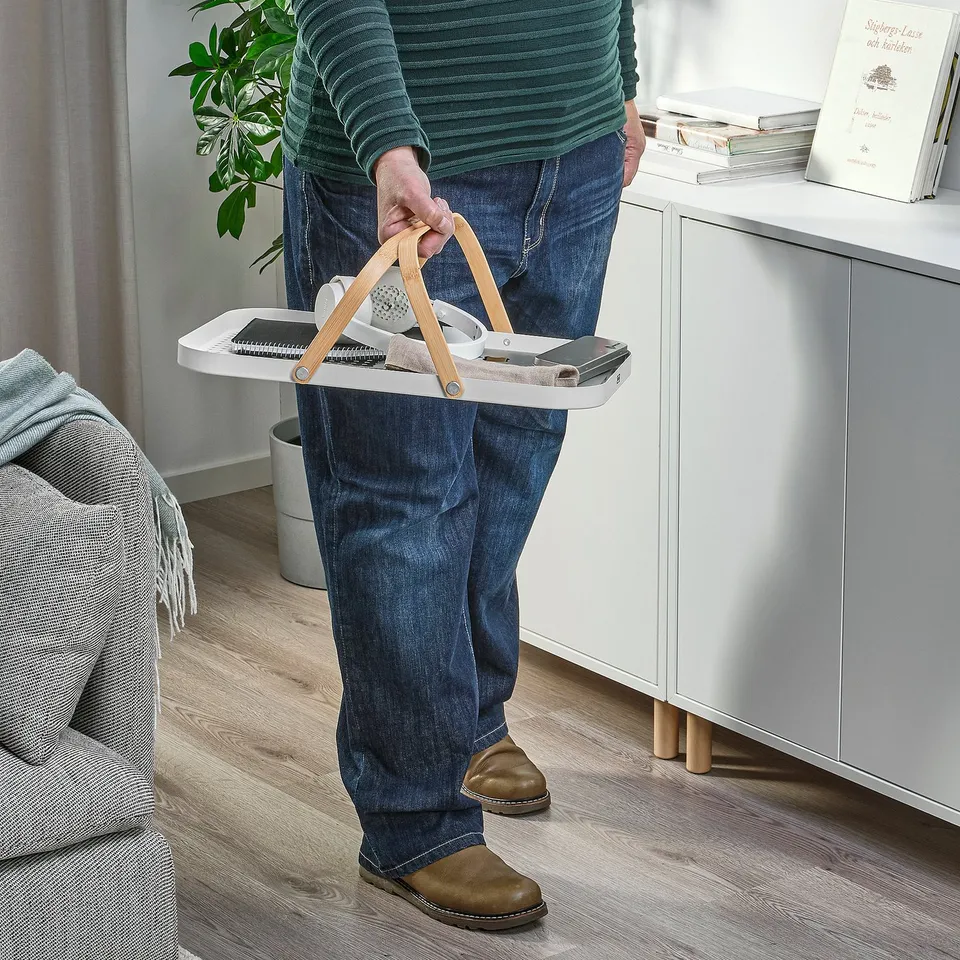 Person holding GRÖNFISK tray with handles, carrying items.