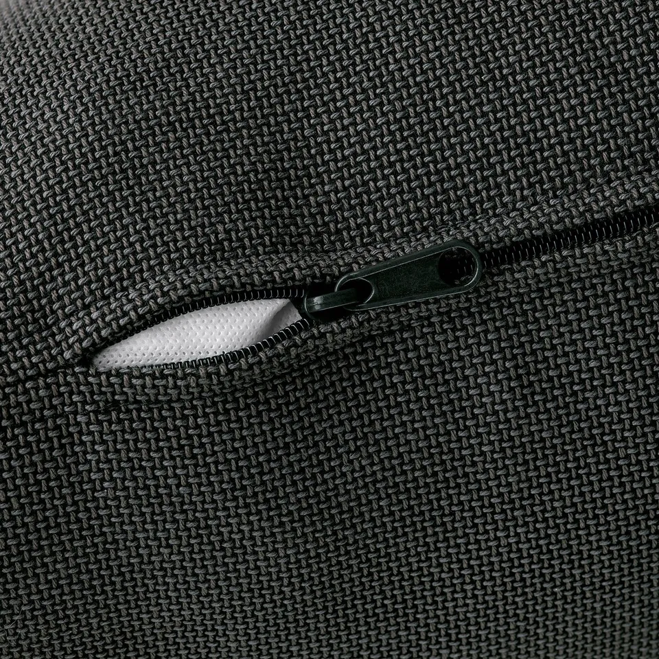 Close-up of a sleek zip on a high-quality, textured fabric, showcasing durability and attention to detail.