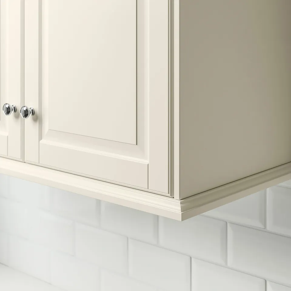 White cabinet trim with chrome knobs, installed under cabinets.