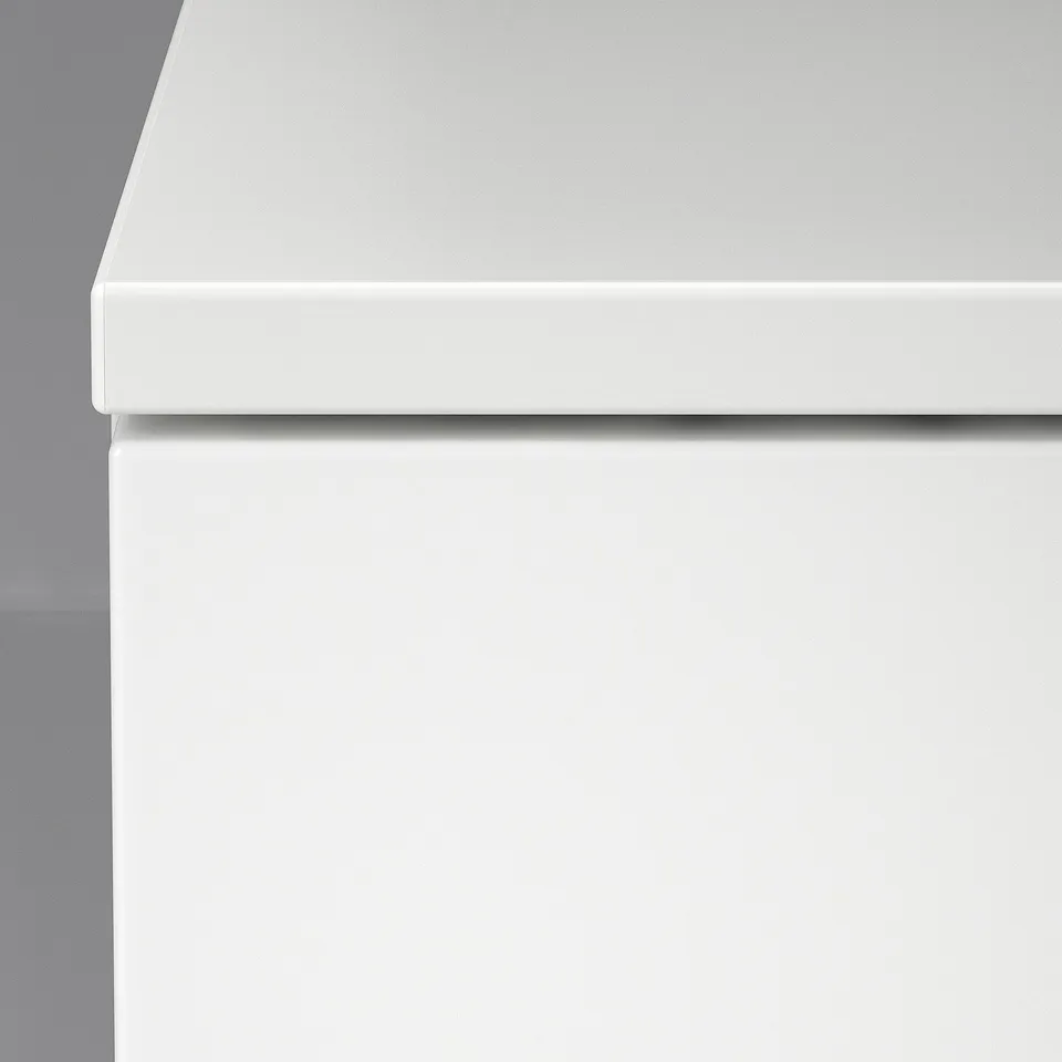 Sleek white chest drawer close-up, smooth finish, modern design.