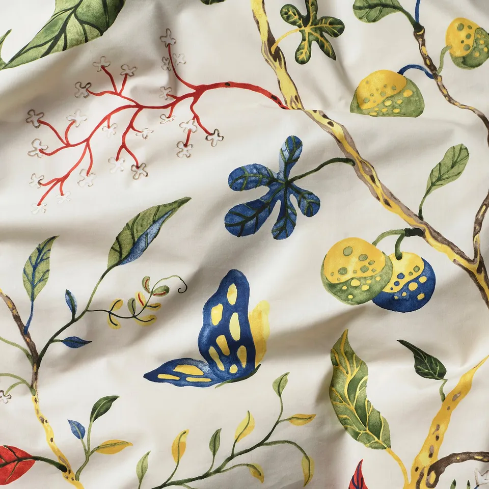 Floral bolster case with vibrant, hand-drawn design on smooth, crisp fabric. Yellow fruits, green leaves, red branches, and blue butterflies.