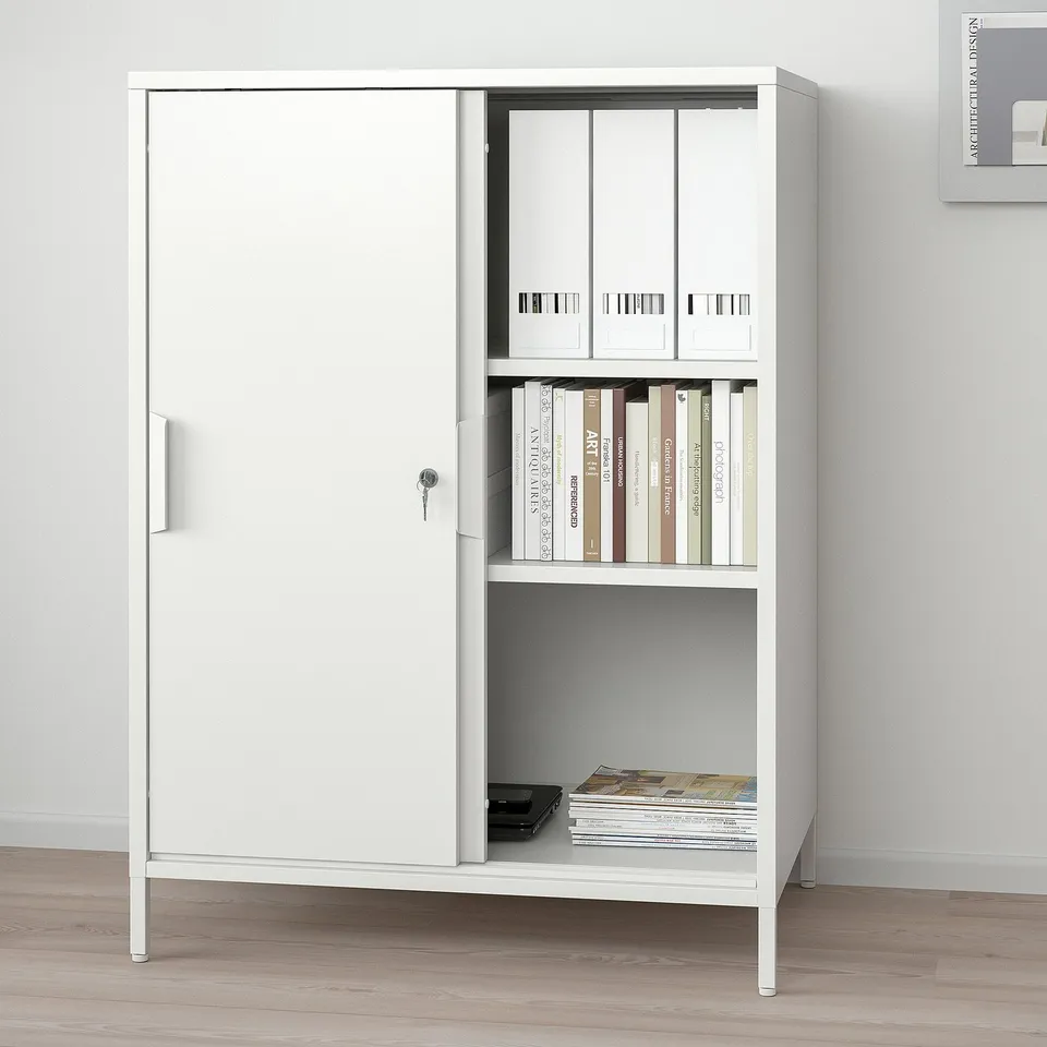 White TROTTEN cabinet with sliding door, open shelves, and storage for files.