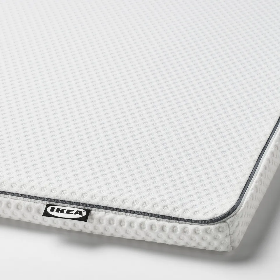 White IKEA foam mattress top, textured surface & zip detail.
