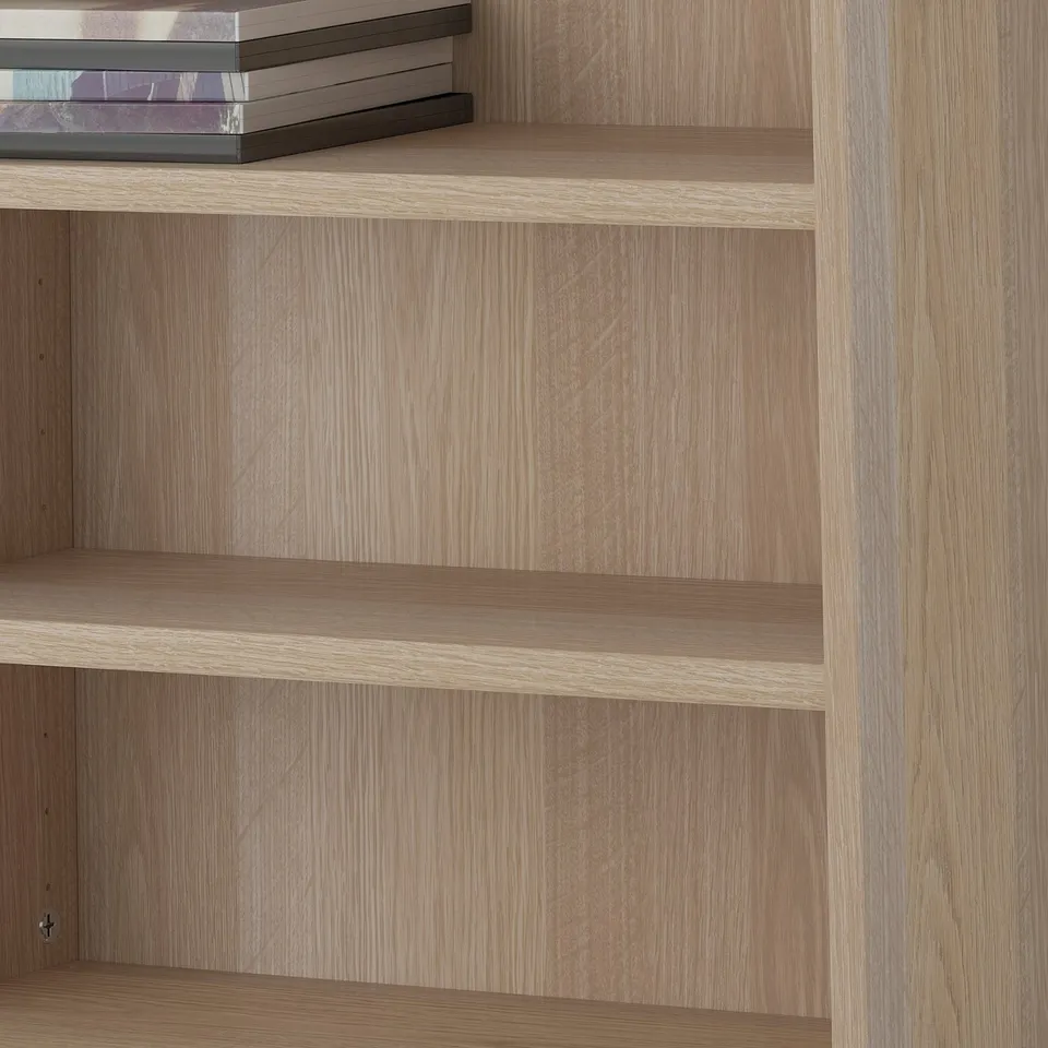 Wooden shelves in bookshelf, adjustable and empty, illustrating customizable storage.