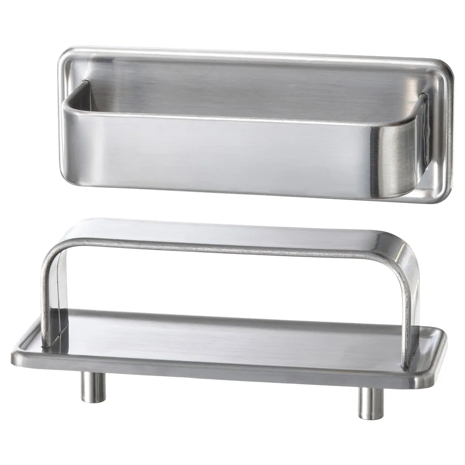 Two stainless steel kitchen accessories: a long rectangular handle and a small tray with two legs, designed for a modern yet retro look.