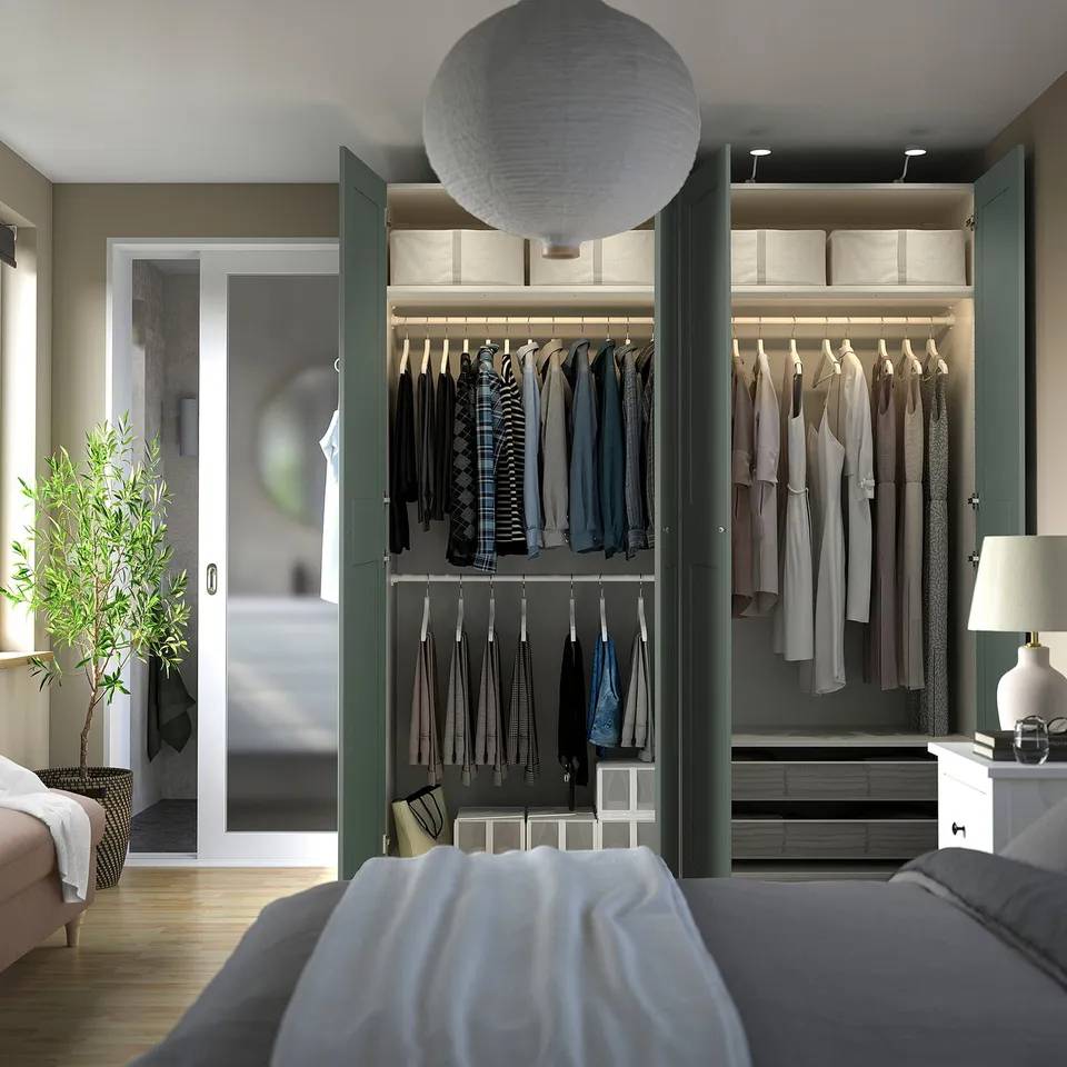 Open wardrobe with clothes and shelves. Soft lighting, adjustable interior.