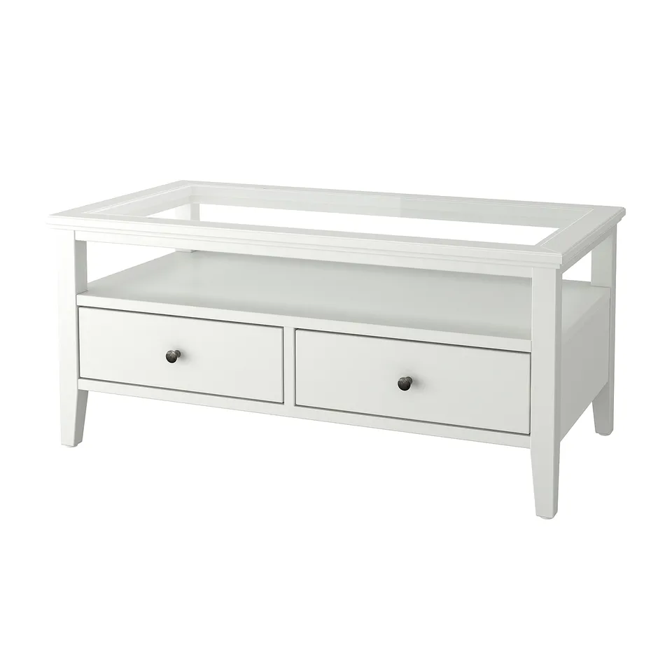 White IDANÄS coffee table, rectangular with glass top, two drawers, wooden frame, sleek design.
