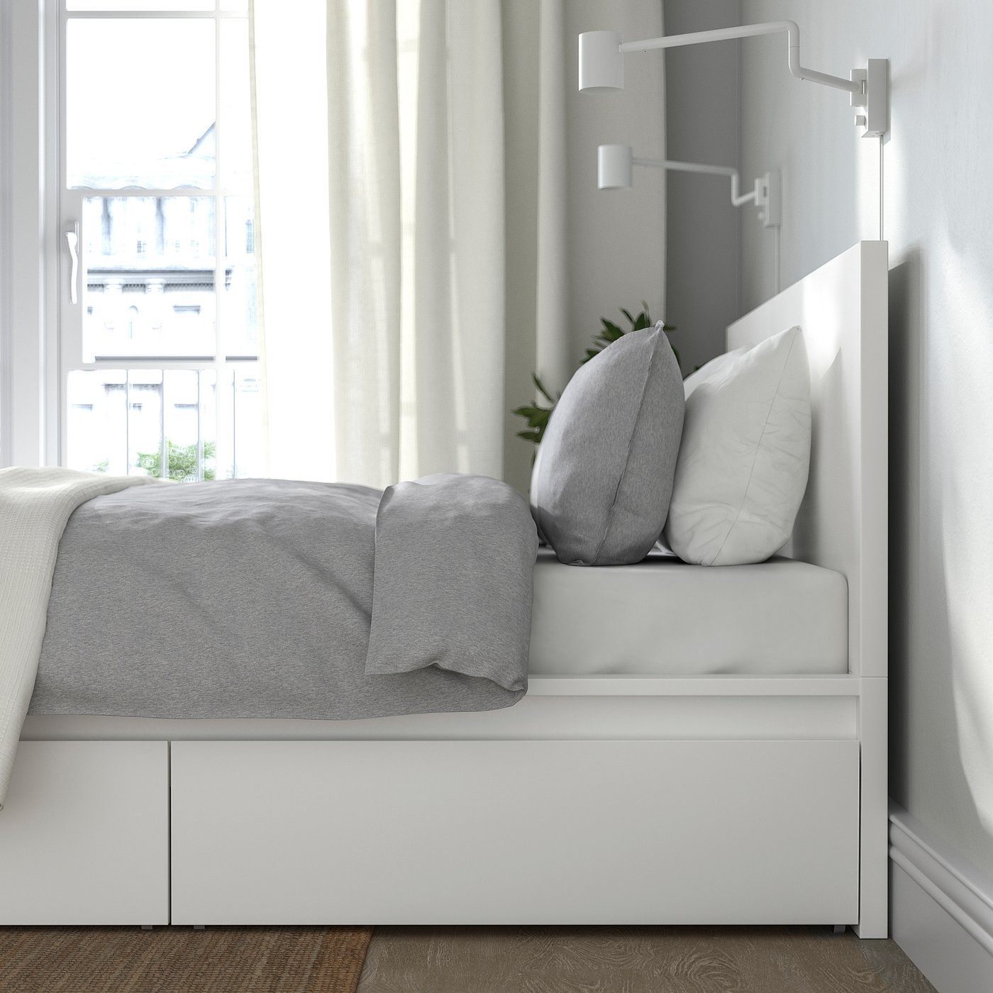 Bed with drawers and pillows, attached reading light, large window.