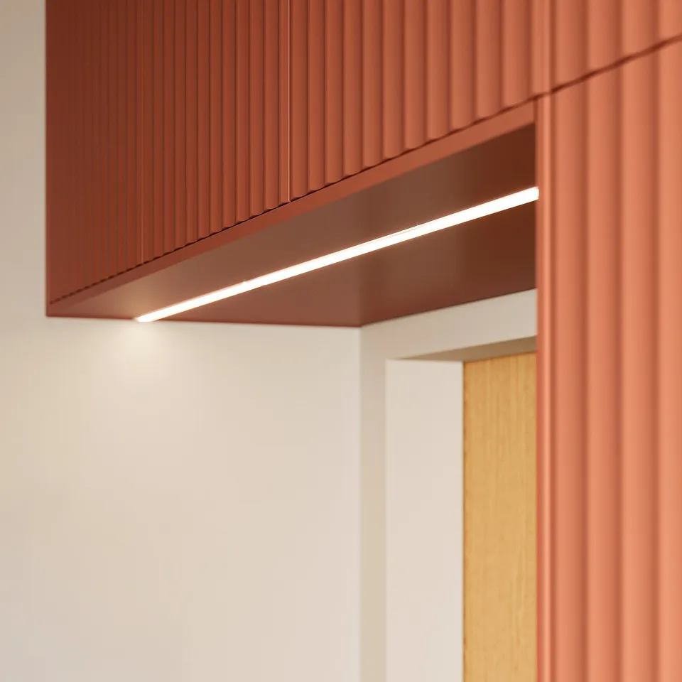 Red-brown TERRSJÖ panel with led lighting, sleek and modern kitchen design.