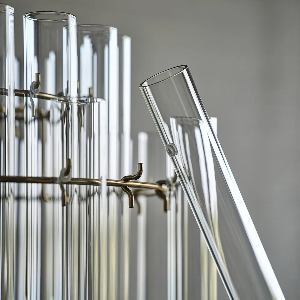 Chandelier with multiple glass cylinders suspended by metal hooks, reflecting high-quality design and craftsmanship.