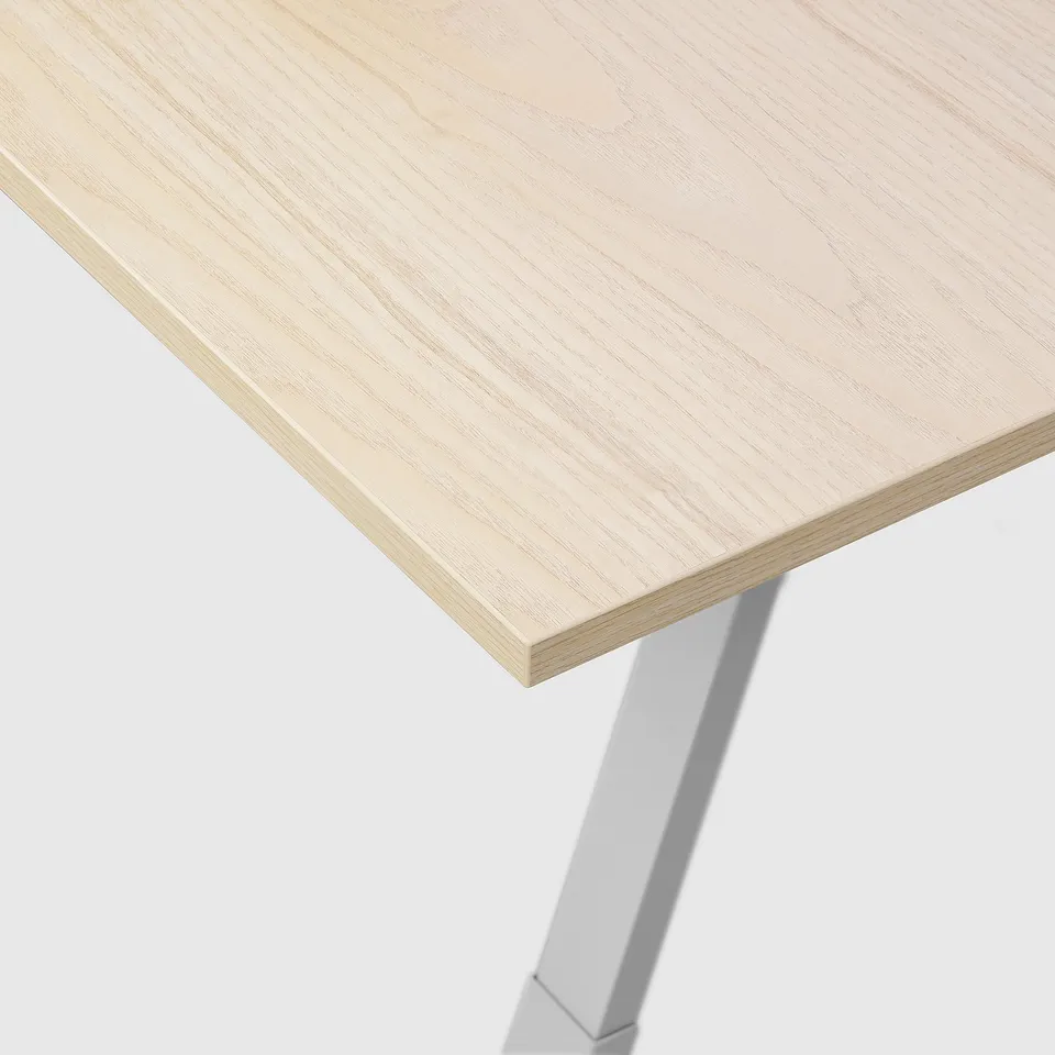 Modern desk with light wood top and metal legs. Strong, clean design.