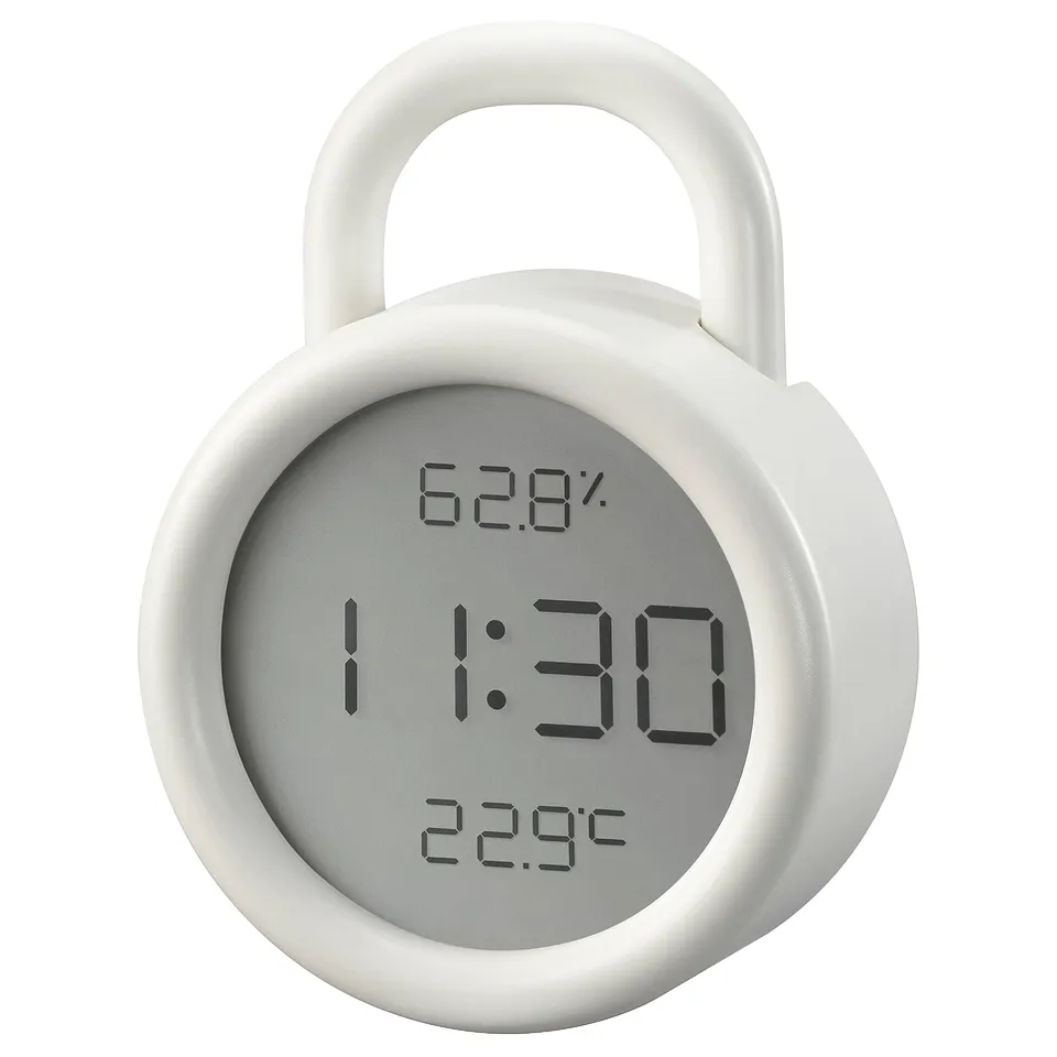 A round, white ÖRNVRÅK clock with a hook, displaying time, temperature, and humidity. The screen shows 11:30, 62. 8% humidity, and 22. 9°c.