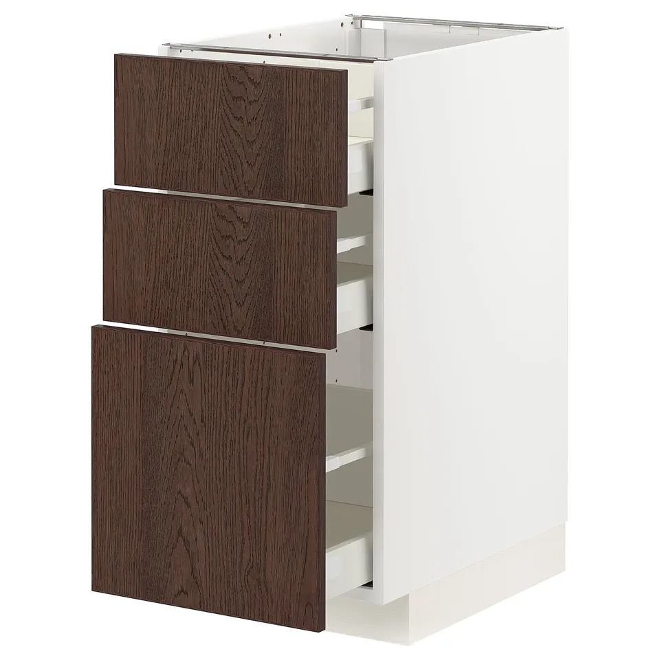 A white METOD kitchen cabinet with three dark brown sinarp wooden drawers. It has a modern design with sleek drawer handles.