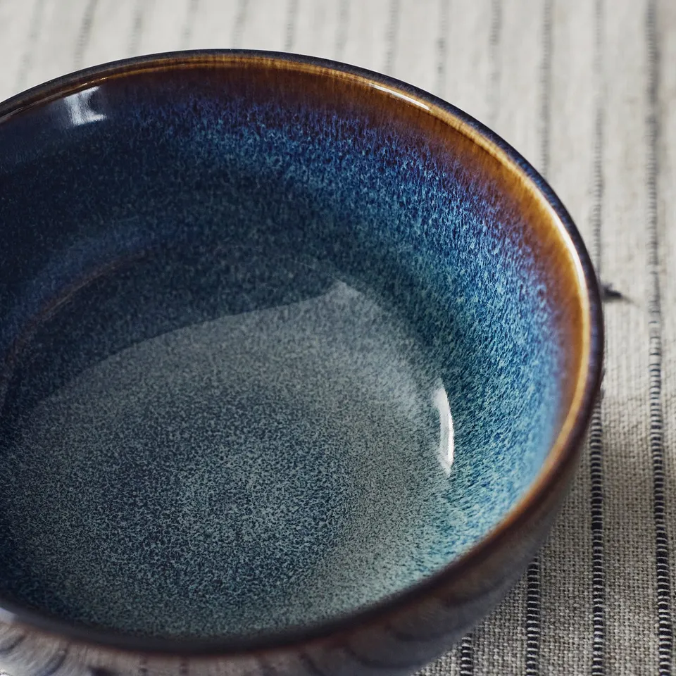 Blue bowl with gold rim.