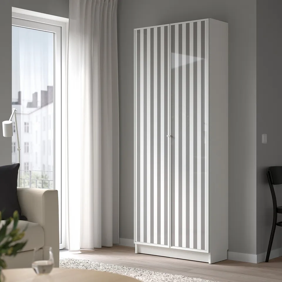 BILLY white bookcase near window, tall, minimalist design.