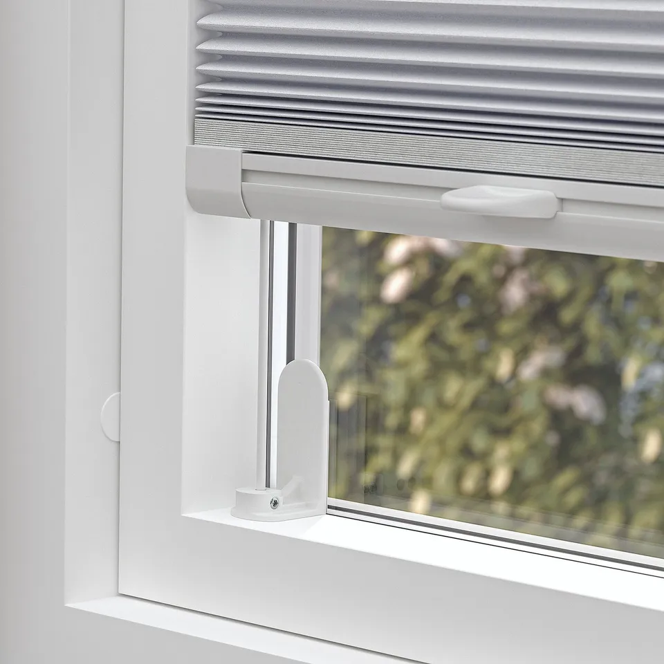 Pleated blind partially drawn, cordless, with side brackets.
