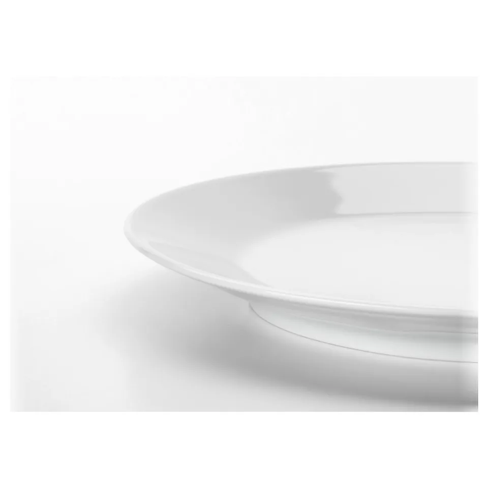 A clean, white plate with smooth edges, part of IKEAs durable and timeless dinnerware set.