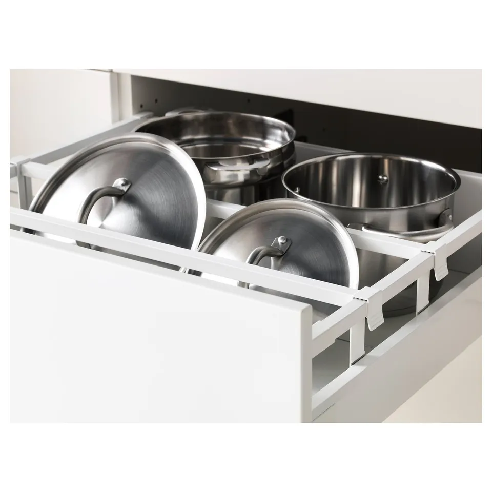 White kitchen drawer with three organised stainless steel pots and lids, showcasing adjustable shelves and full-extension capability.