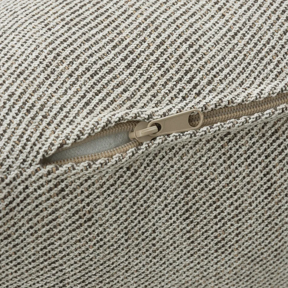 Close-up of a zip on a textured, multi-colored cushion cover, showcasing high-quality fabric and durable zip.