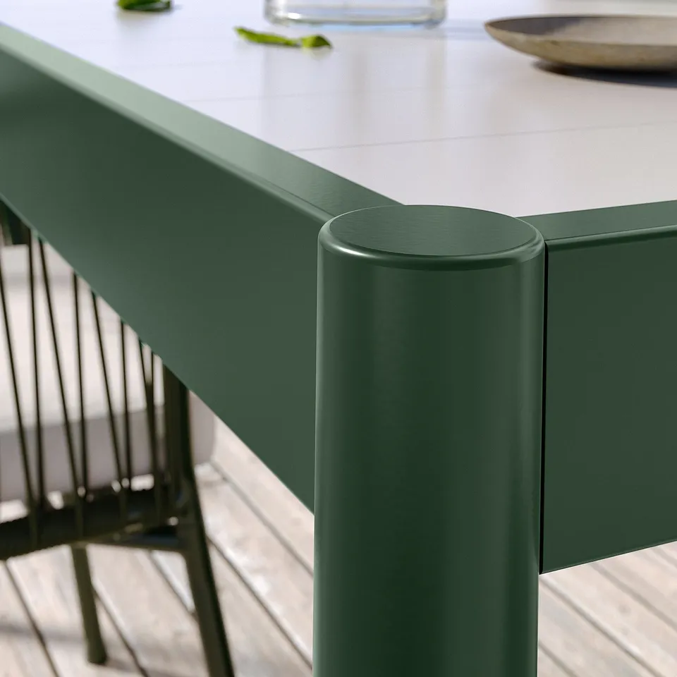 Green outdoor table and chair set, modern, sturdy metal design.