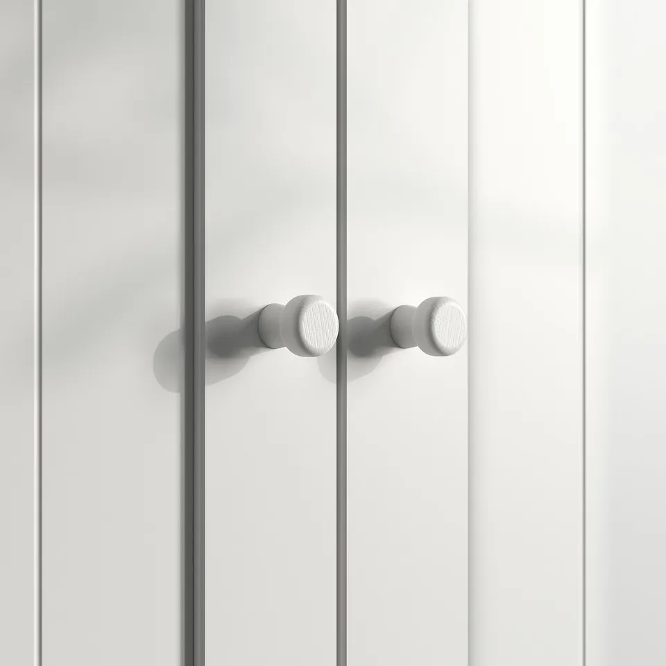 The GULLABERG white cabinet door with five spherical handles in a row.
