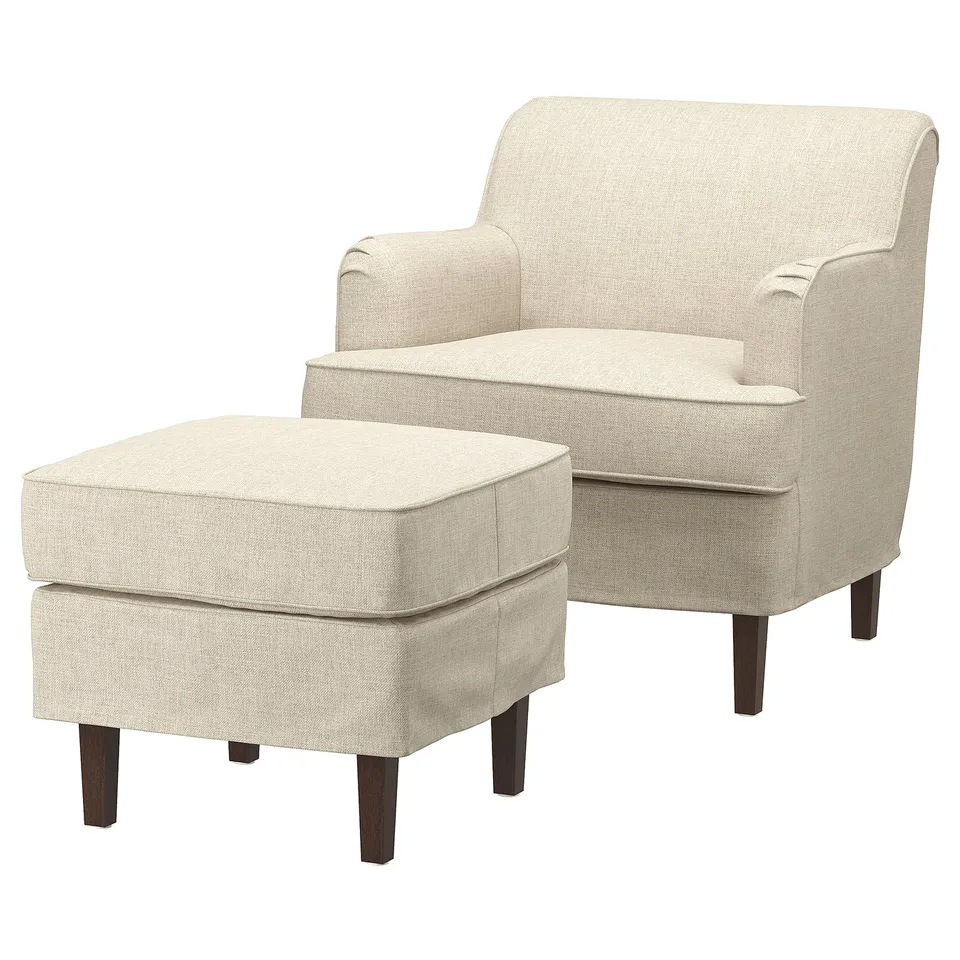 A beige ROCKSJÖN armchair and footstool with dark wooden legs, featuring a traditional, textured fabric design.