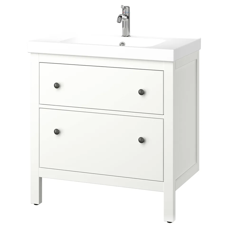 A HEMNES white bathroom cabinet with a ceramic sink and chrome-faucet, featuring two smooth-running drawers.
