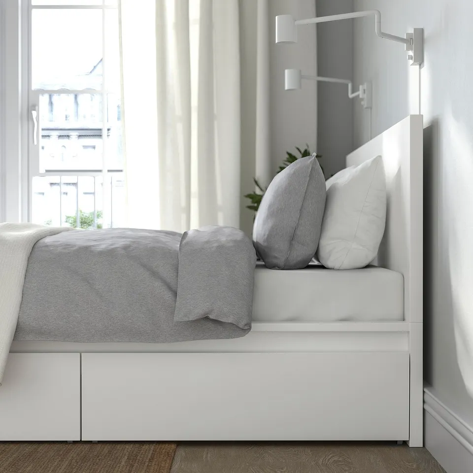 Clean, modern bed with high headboard, built-in drawers, and pillows; excellent for seating and storage.