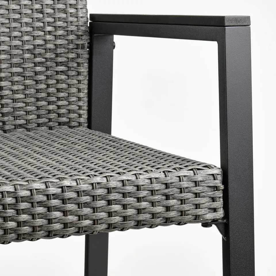 Close-up of durable, weather-resistant patio chair with woven material and metal frame.