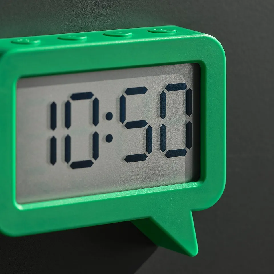 Bright green digital clock, displaying 10:59, with bold numbers on clear screen.
