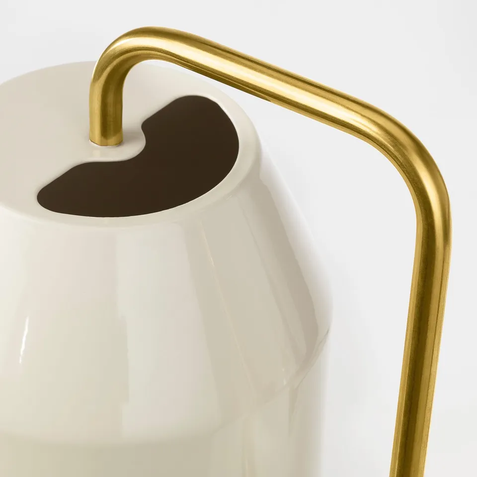 Gold-handled white watering can, showcasing sleek design and high-quality materials.