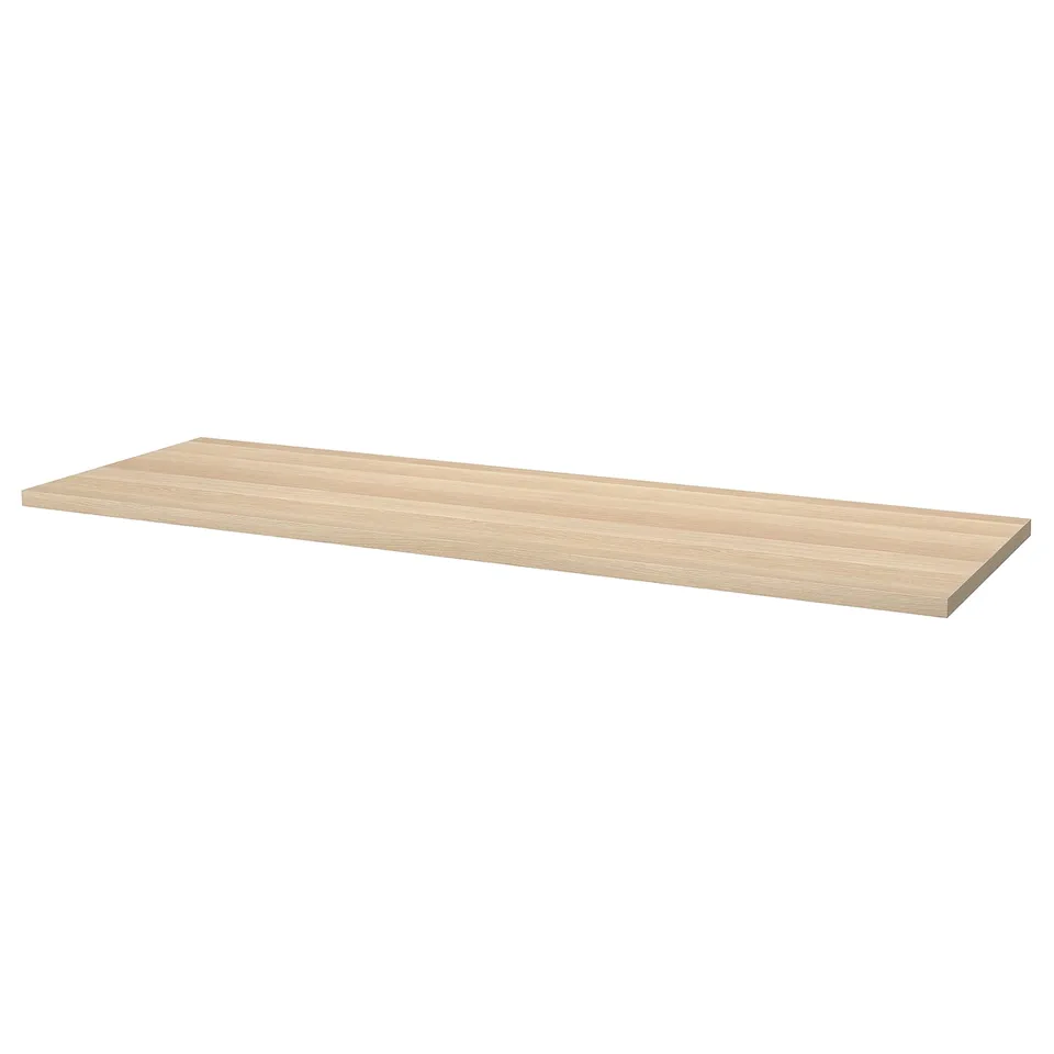 An ikea LAGKAPTEN desk top in light oak color, rectangular shape, with a smooth surface ready for assembly.