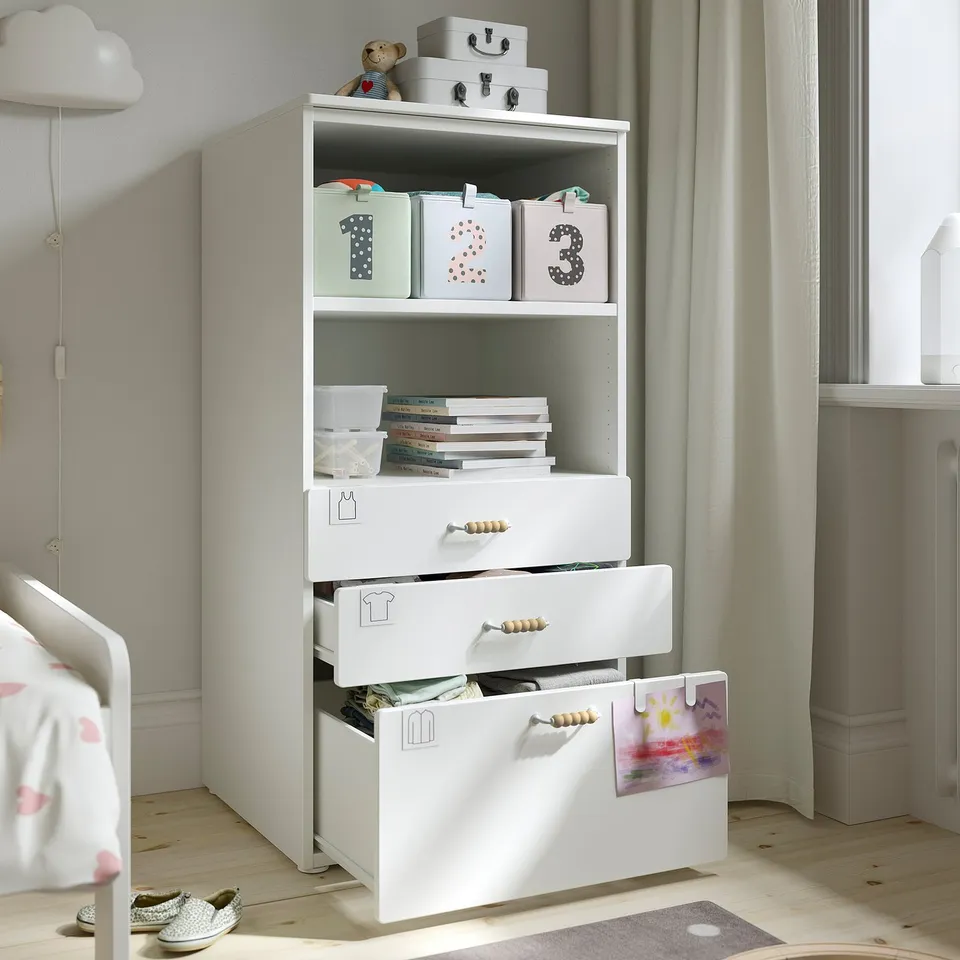 Childrens storage unit with open shelves for books and toys, and multiple drawers for extra storage.