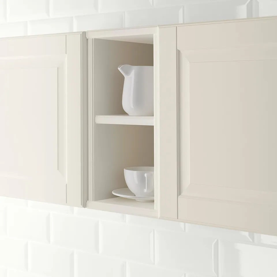 Open kitchen cabinet with jug and bowl, showcasing storage and display functionality.
