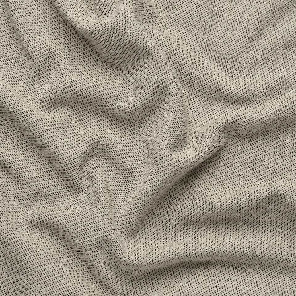 Close-up of a soft, textured fabric with subtle patterns, likely a sofa or curtain material, showcasing its fine texture and quality weave.