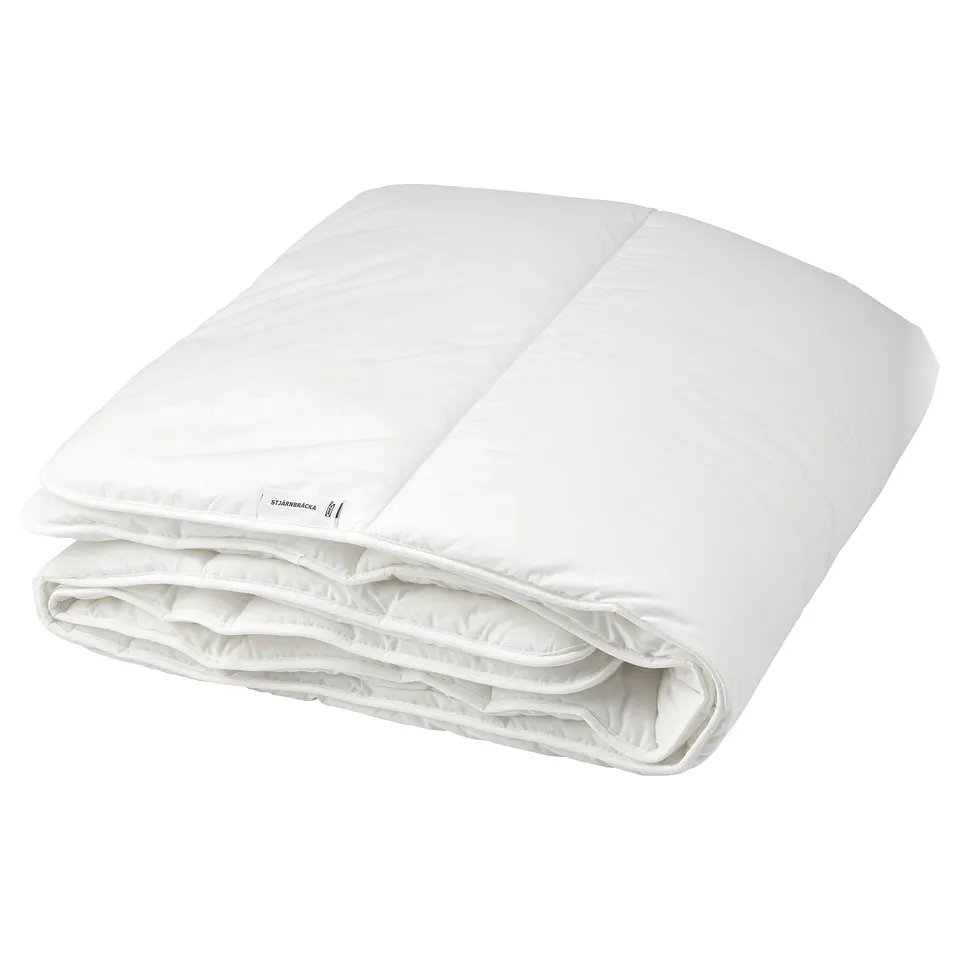 White STJÄRNBRÄCKA duvet, thick and rectangular, made with lyocell and cotton, providing extra warmth.