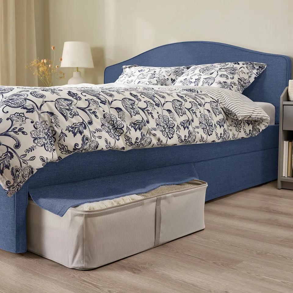 Cosy bed with curved headboard, padded for comfort. Storage boxes under the skirt for extra space.