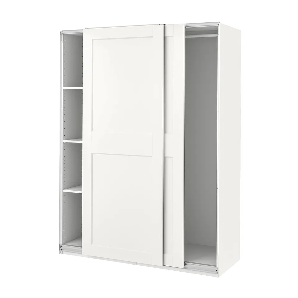 A white PAX wardrobe with sliding doors and internal shelves. It is modern and minimalist.