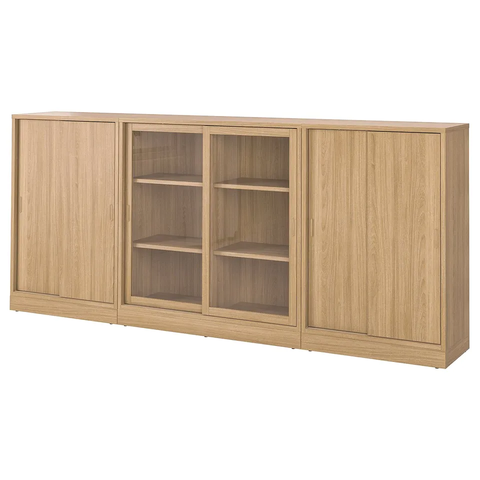 A TONSTAD wooden cabinet set in oak colour, featuring sliding doors and adjustable shelves for versatile storage.