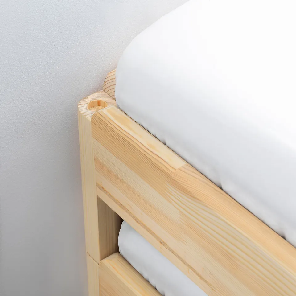 Close-up of a sturdy, wooden bunk bed frame with a smooth, white mattress. The natural wood grain and clean finish enhance its quality and durability.