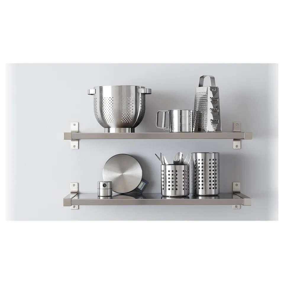 Stainless steel kitchen shelves holding cooking utensils.