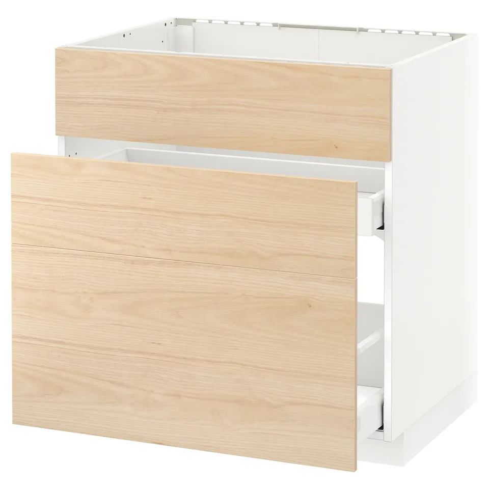 A white ikea METOD kitchen cabinet with a light ash wood-patterned drawer and a partially open drawer.